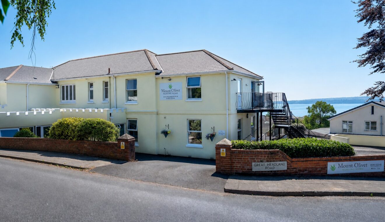 Mount Olivet Nursing Home viewed from Great Headland Road, with Torbay visible behind the building