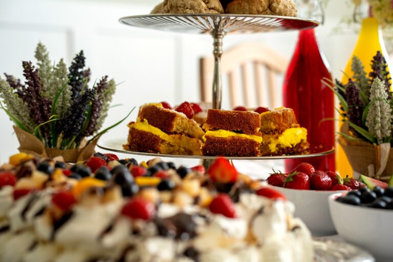 A close-up of sponge cake with cream and jam on the tea trolley