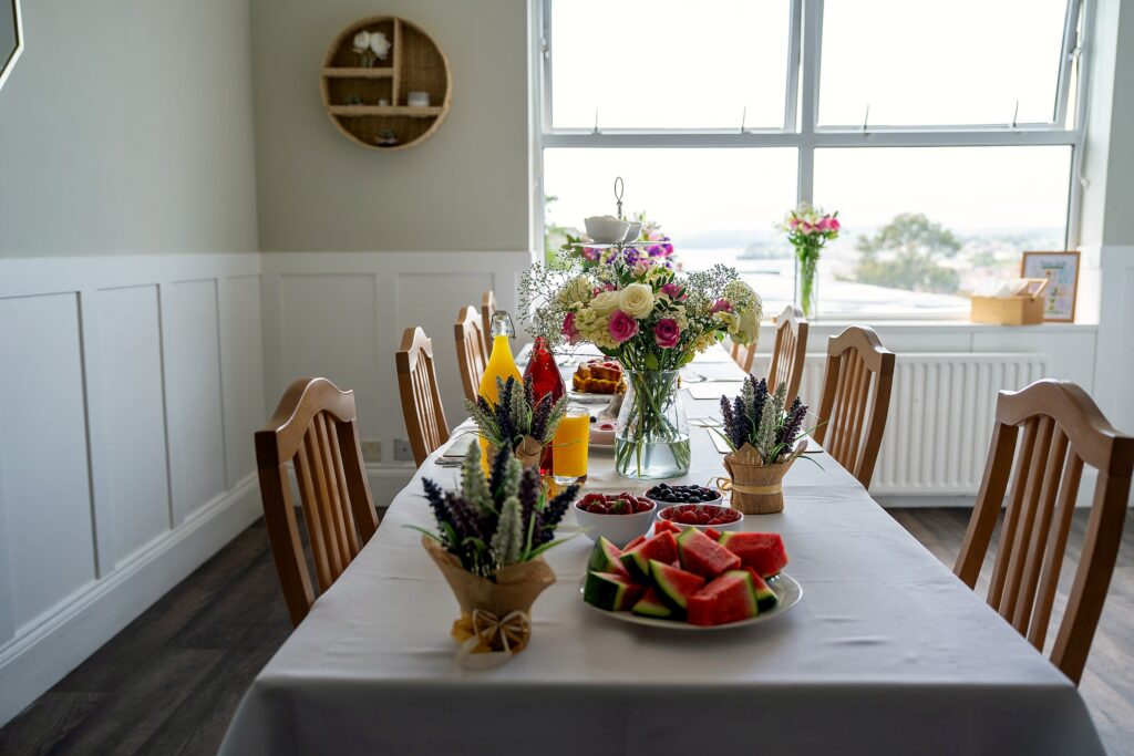 A dining table set with afternoon tea, overlooking the garden
