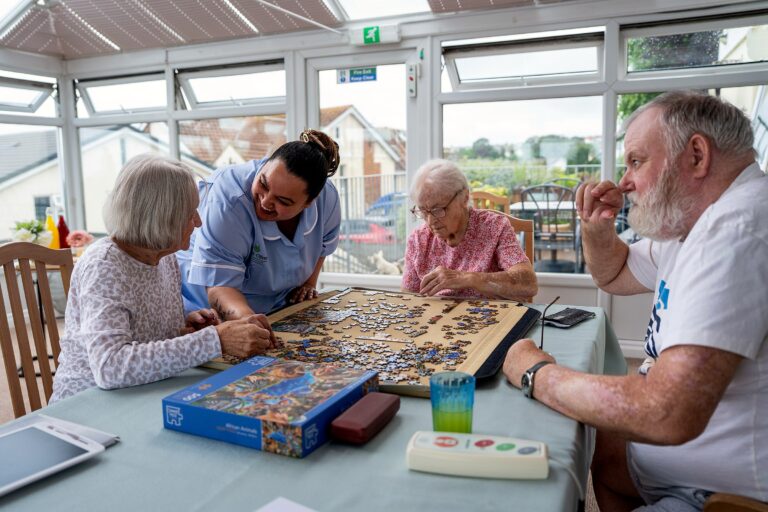 Residents taking part in a group jigsaw puzzle activity